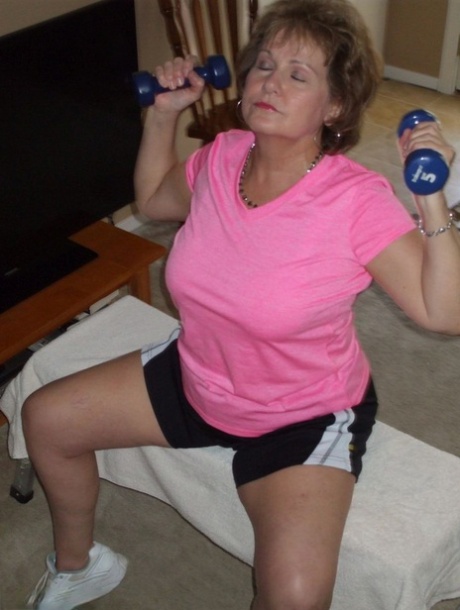 Mature woman Busty Bliss exposes her natural boobs while working out at home 19760226