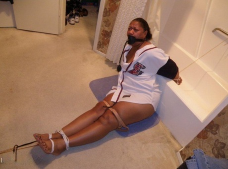 Ebony plumper is silenced with a pump up gag while restrained in a bathroom 49025919