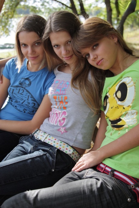 3 young girls remove T-shirts and jeans to model naked on park bench 70007568