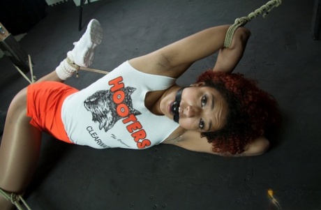 Ebony girl Daisy Ducati is masturbated while restrained in her clothing 64019115