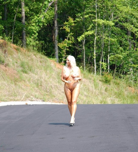 Thick blonde Karen Fisher stands naked in parking lot while modeling naked 98777571