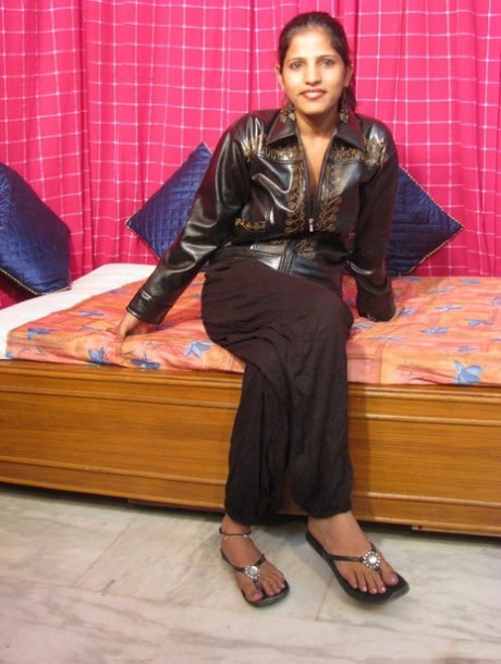 Indian MILF unveils her natural tits while getting butt naked on a bed