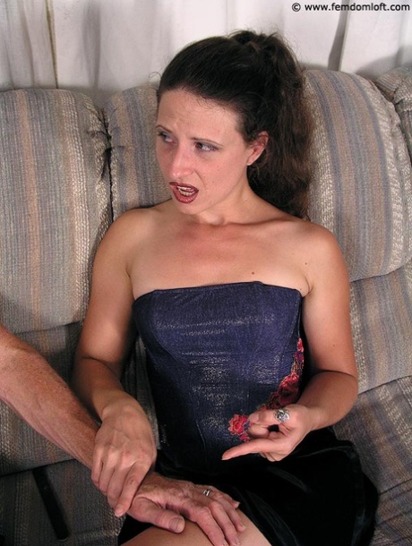 Dominant woman spanks a submissive man's bare ass over her knee 63786579