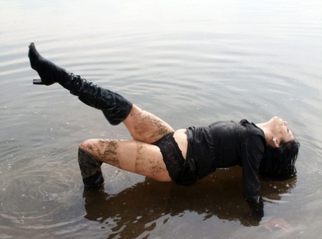 Dark haired girl Lilu gets wet and dirty while wearing over the knee boots