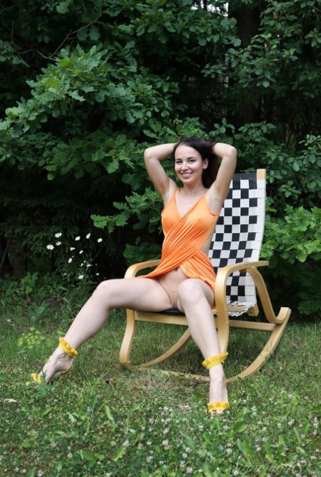 Barely legal brunette Nicole V gets naked on a backyard rocking chair 38117238