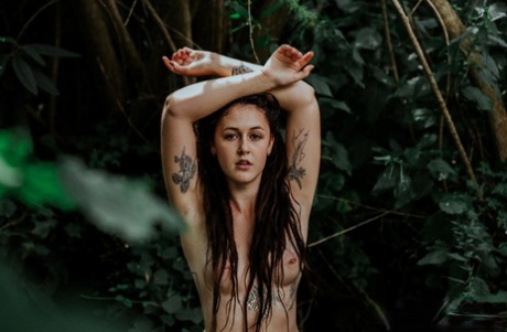 Tattooed brunette Jiajialaz models naked while in the jungle 43667027