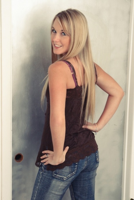 Beautiful blonde holds her denim jeans after getting undressed 53953464