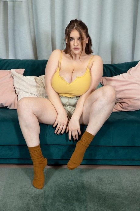 Solo girl Molly Evans pulls out her massive boobs upon a sofa 11697428