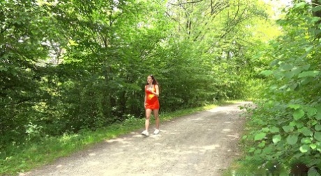 Brunette chick Ali Star takes a piss on a bench alongside a rural walking path 71884443