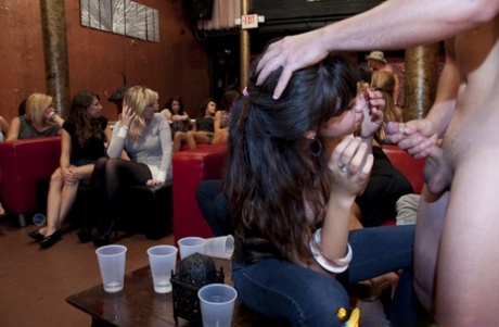 Clothed chicks are enjoying cum on their faces from a sexy stripper