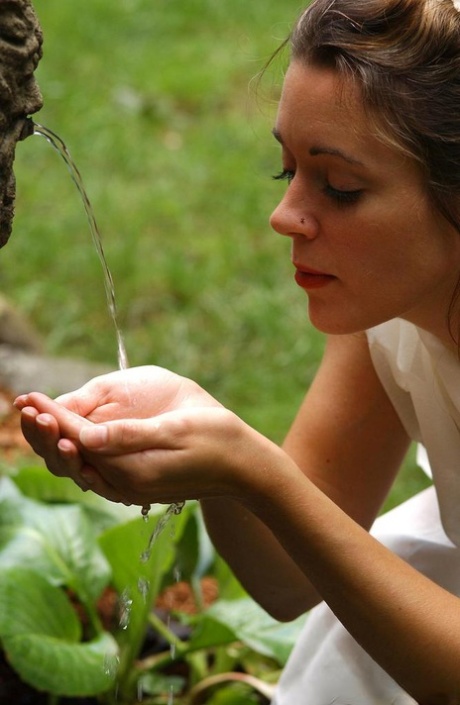 Garden nymph seduces a meditating man out in the garden 90441691